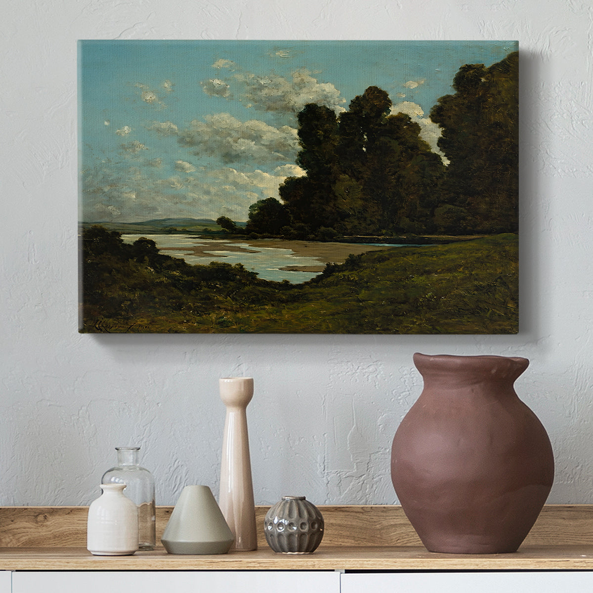 Canvas art print featuring a countryside waterway with town along horizon, styled above a decorative console