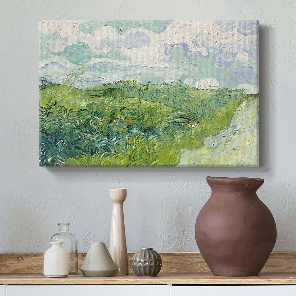 Canvas art print featuring an expressive landscape dominated by green crops and open sky, styled above a decorative console
