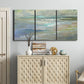 Three-panel canvas wall art featuring soft coastal beach light landscape, displayed above a cabinet in an entryway.