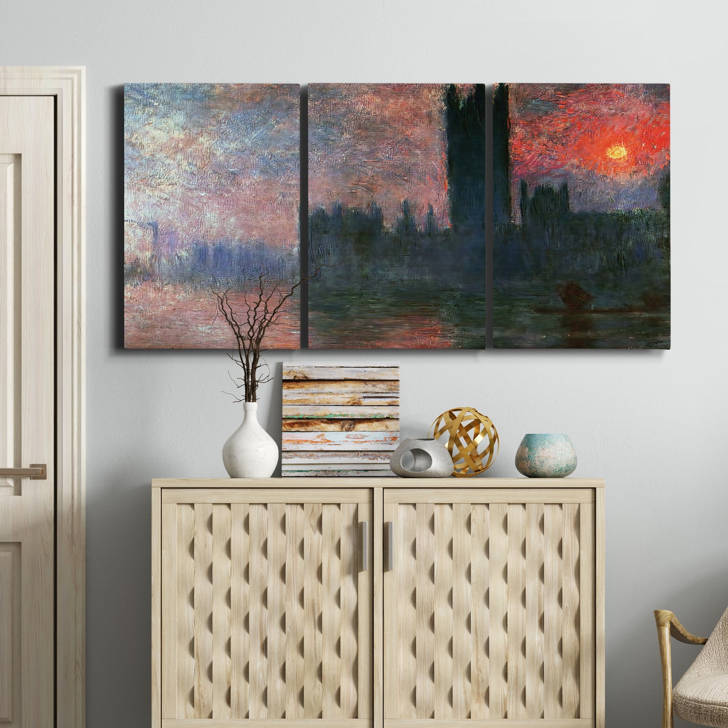 Three-panel canvas wall art featuring parliament silhouetted at dusk, displayed above a cabinet in an entryway.