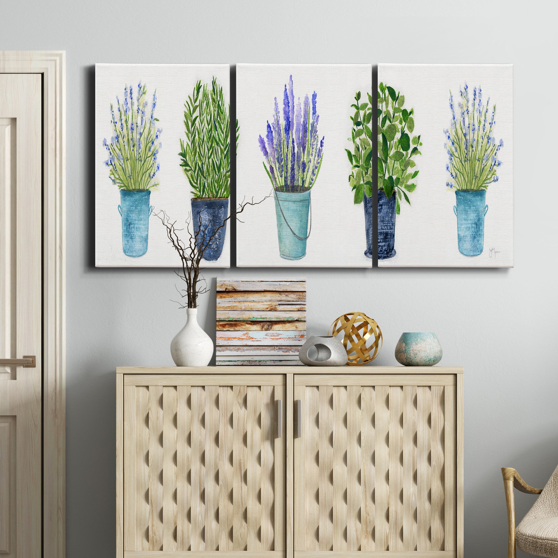 Three-panel canvas wall art featuring minimal monochrome abstract forms, displayed above a cabinet in an entryway.