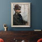 Impressionist portrait of a seated man by Édouard Manet in an ornate champagne frame displayed in a dark-toned interior setting.
