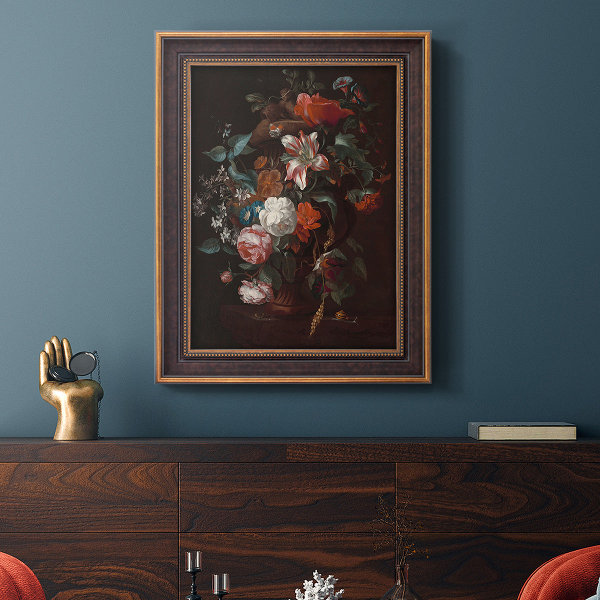 Classical floral still life painting by Jan van Huysum in an ornate bronzed mahogany wood frame displayed in a dark-toned interior setting.