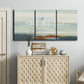 Three-panel canvas wall art featuring nautical abstract suggesting drifting calm, displayed above a cabinet in an entryway.