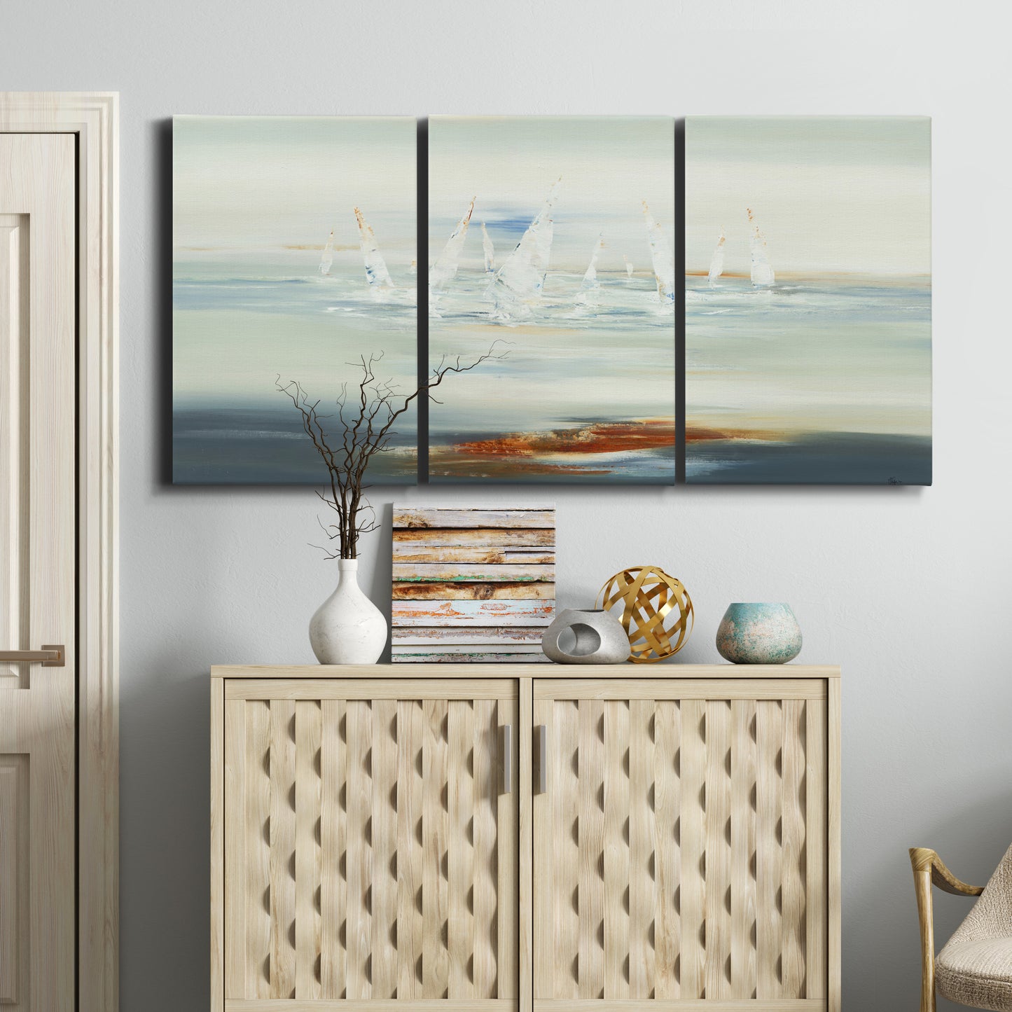 Three-panel canvas wall art featuring nautical abstract suggesting drifting calm, displayed above a cabinet in an entryway.