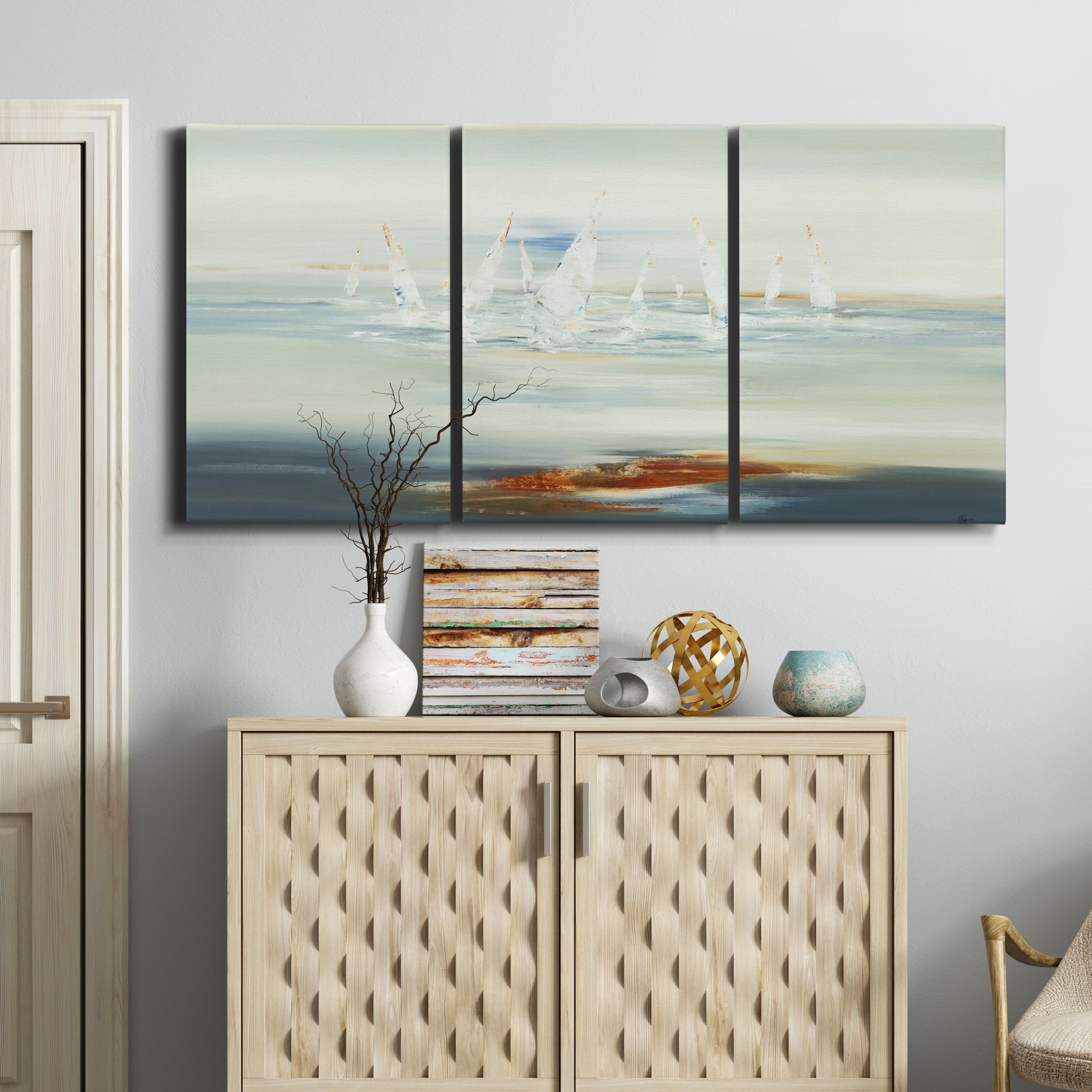 Three-panel canvas wall art featuring nautical abstract suggesting drifting calm, displayed above a cabinet in an entryway.