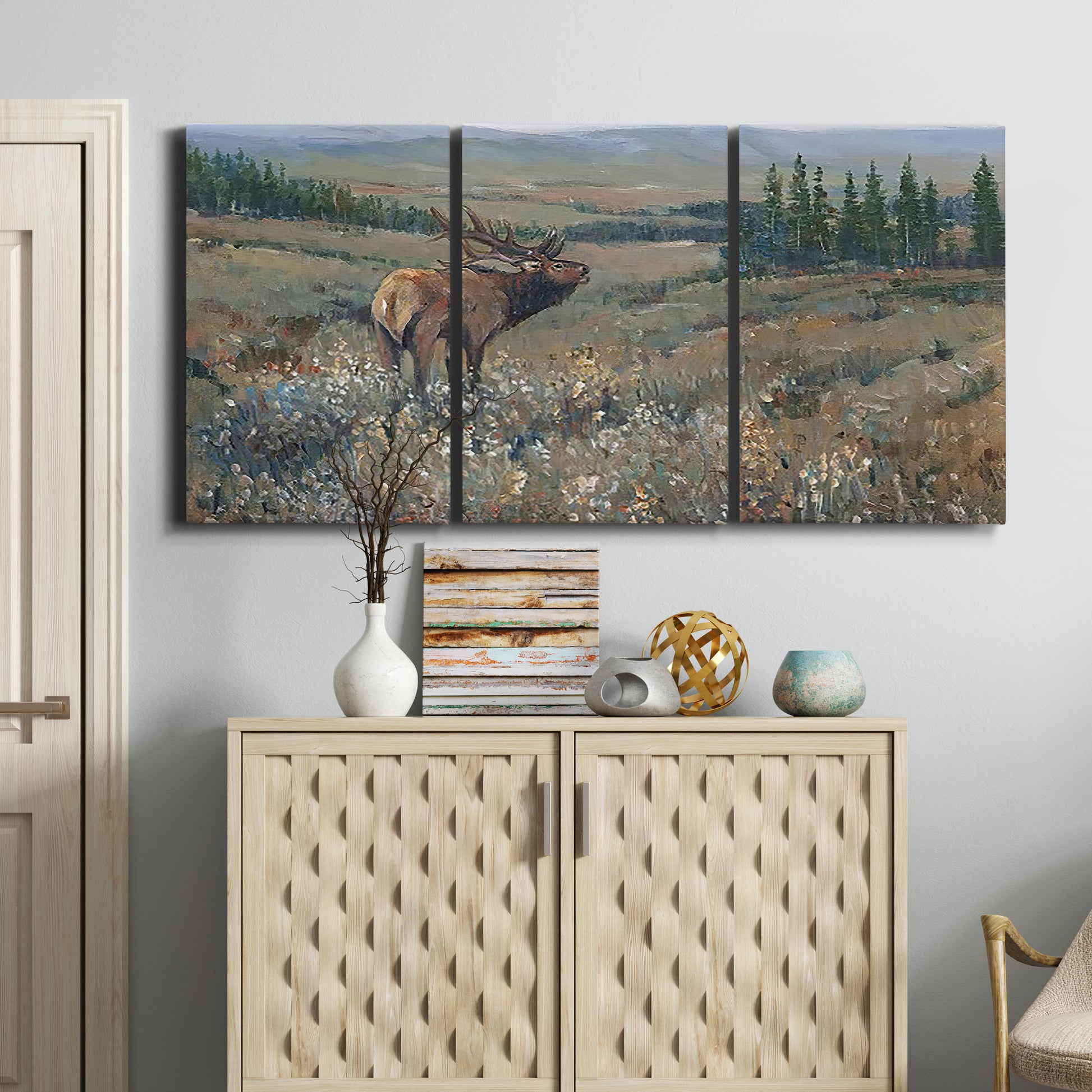Three-panel canvas wall art featuring western wildlife grazing in open field, displayed above a cabinet in an entryway.