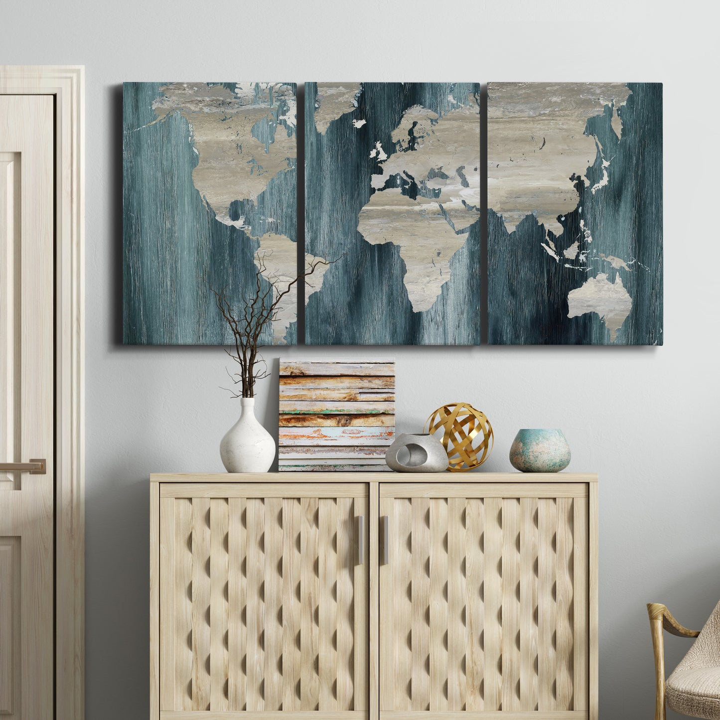 Three-panel canvas wall art featuring golden coastal sunset with cliffs, displayed above a cabinet in an entryway.