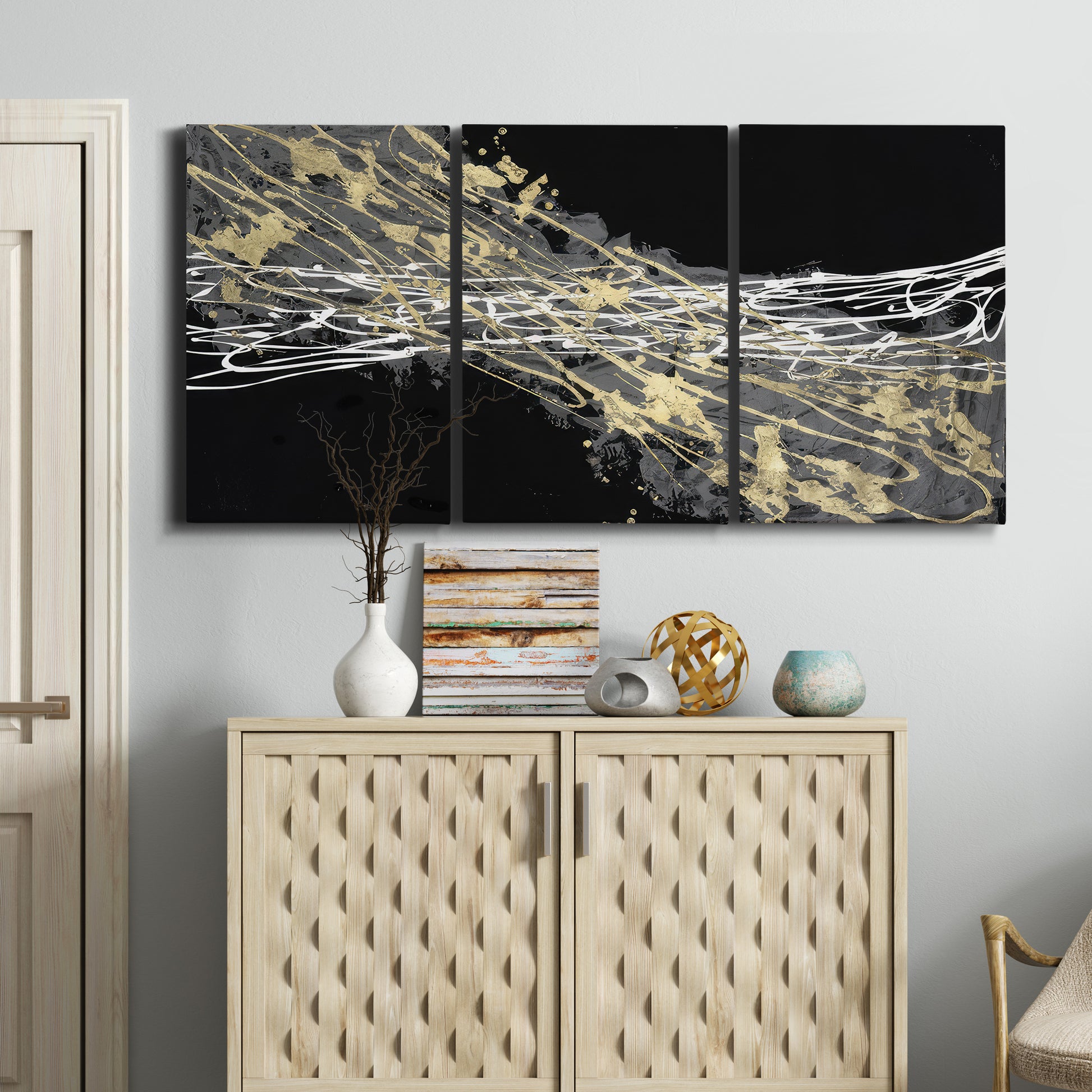 Three-panel canvas wall art featuring dark modern abstract wind patterns, displayed above a cabinet in an entryway.