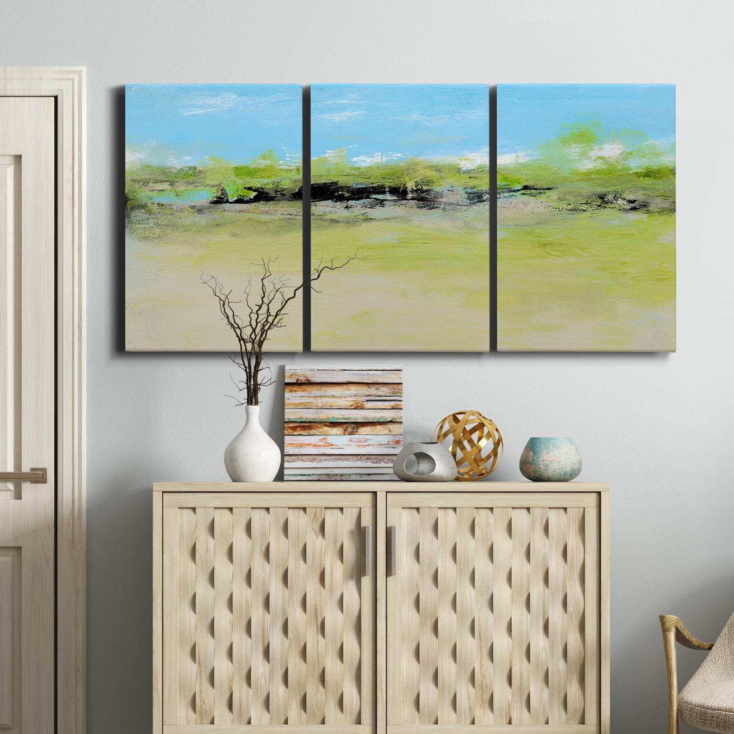 Three-panel canvas wall art featuring abstract terrace landscape view, displayed above a cabinet in an entryway.
