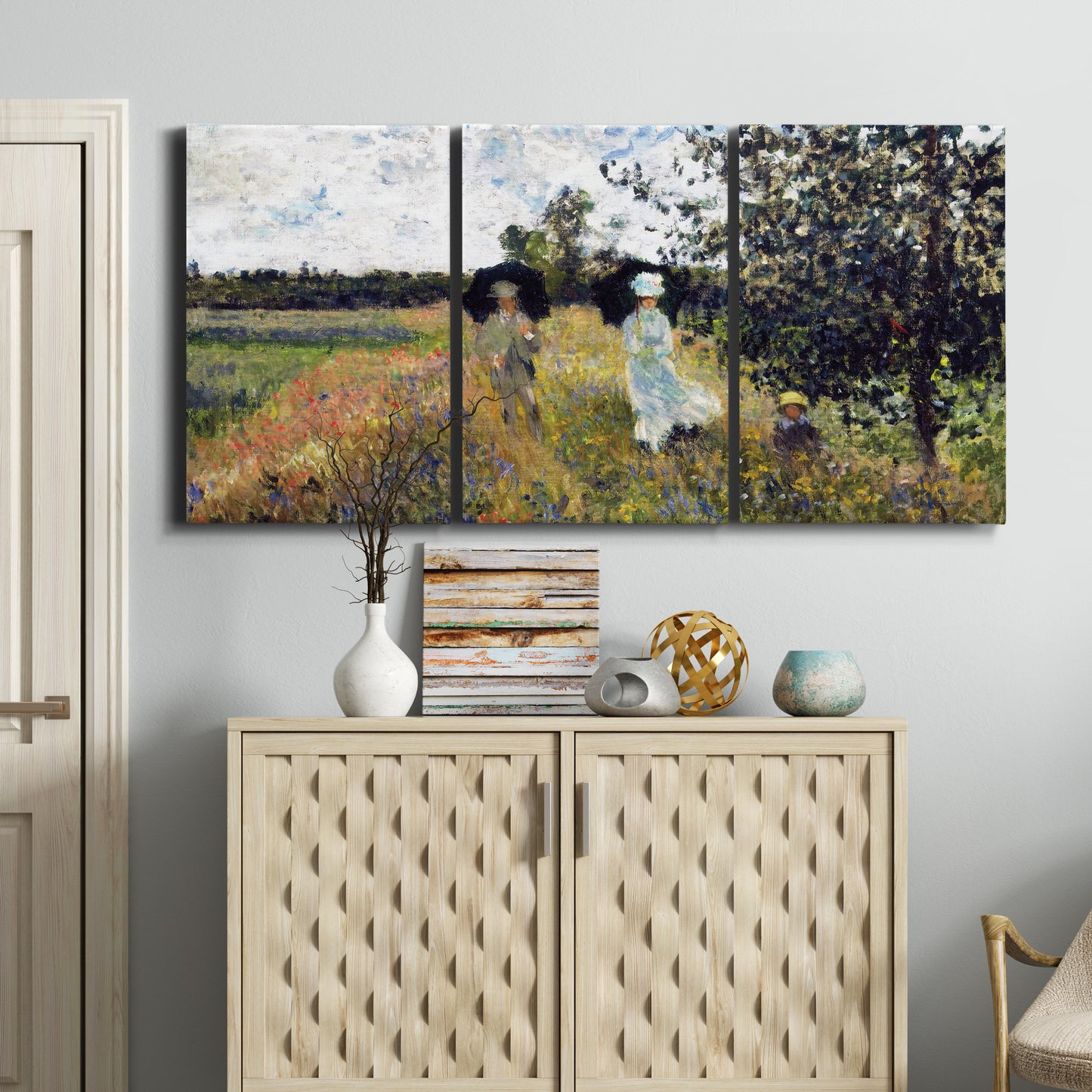 Three-panel canvas wall art featuring figures walking along riverbank, displayed above a cabinet in an entryway.
