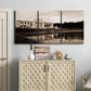 Three-panel canvas wall art featuring monochrome historic pavilion photograph, displayed above a cabinet in an entryway.