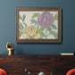 Contemporary peony flower illustration in an ornate traditional bronze frame displayed in a dark-toned interior setting.