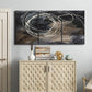 Three-panel canvas wall art featuring dark swirling abstract motion, displayed above a cabinet in an entryway.