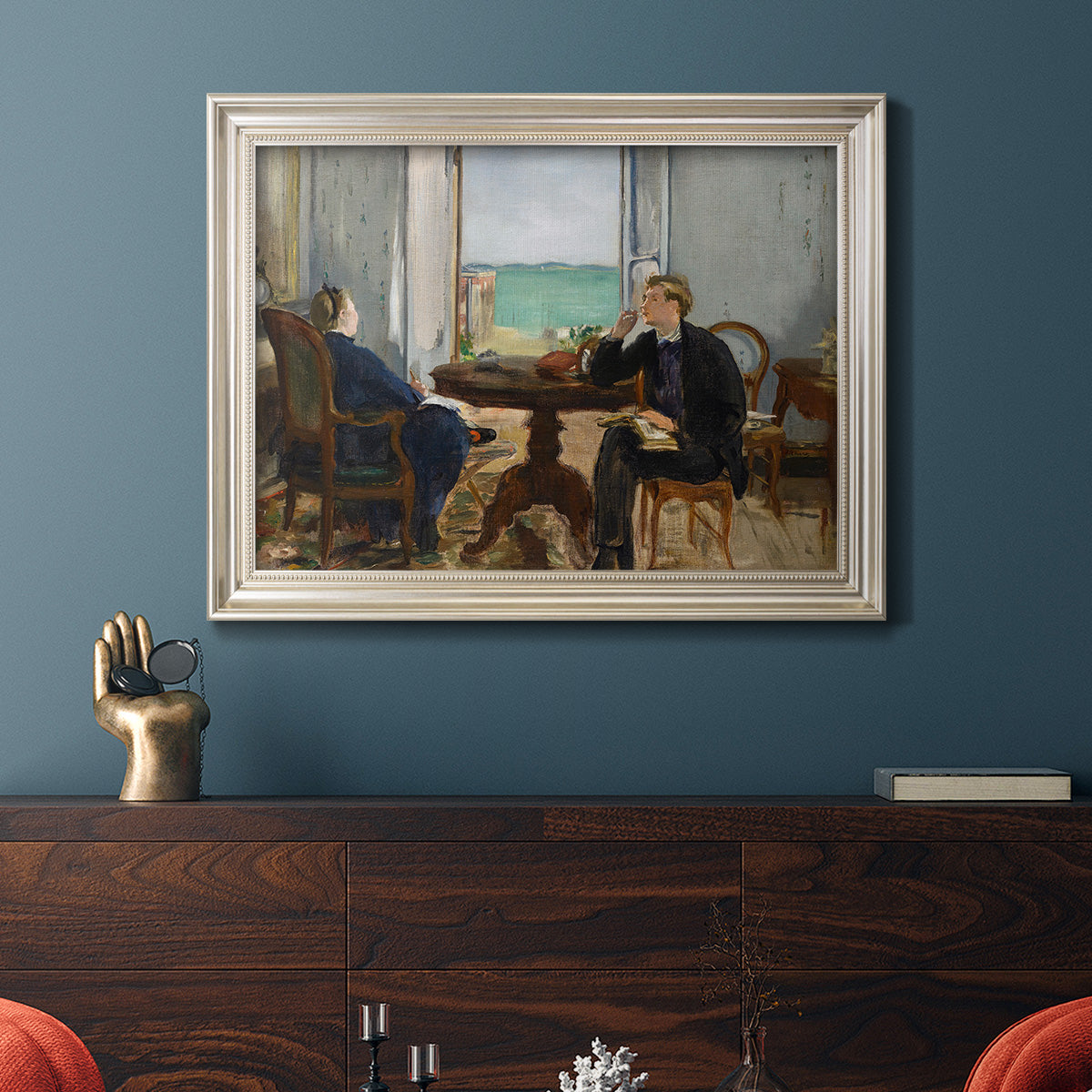 Impressionist interior scene by Édouard Manet in an ornate champagne frame displayed in a dark-toned interior setting.