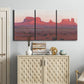 Three-panel canvas wall art featuring red rock desert formations at dusk, displayed above a cabinet in an entryway.