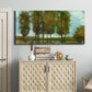 Three-panel canvas wall art featuring tall trees lining open landscape, displayed above a cabinet in an entryway.