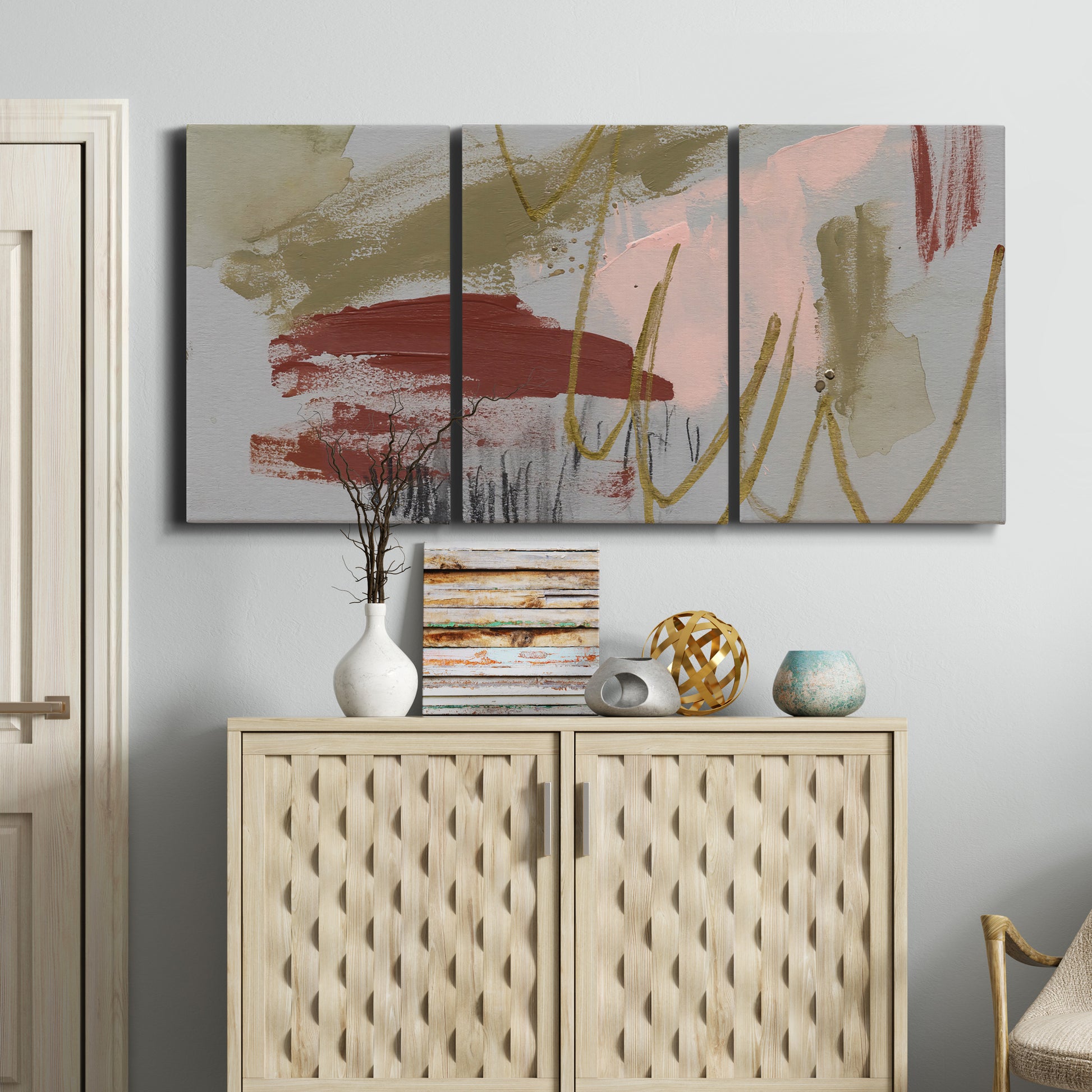 Three-panel canvas wall art featuring minimalist abstract line textures, displayed above a cabinet in an entryway.
