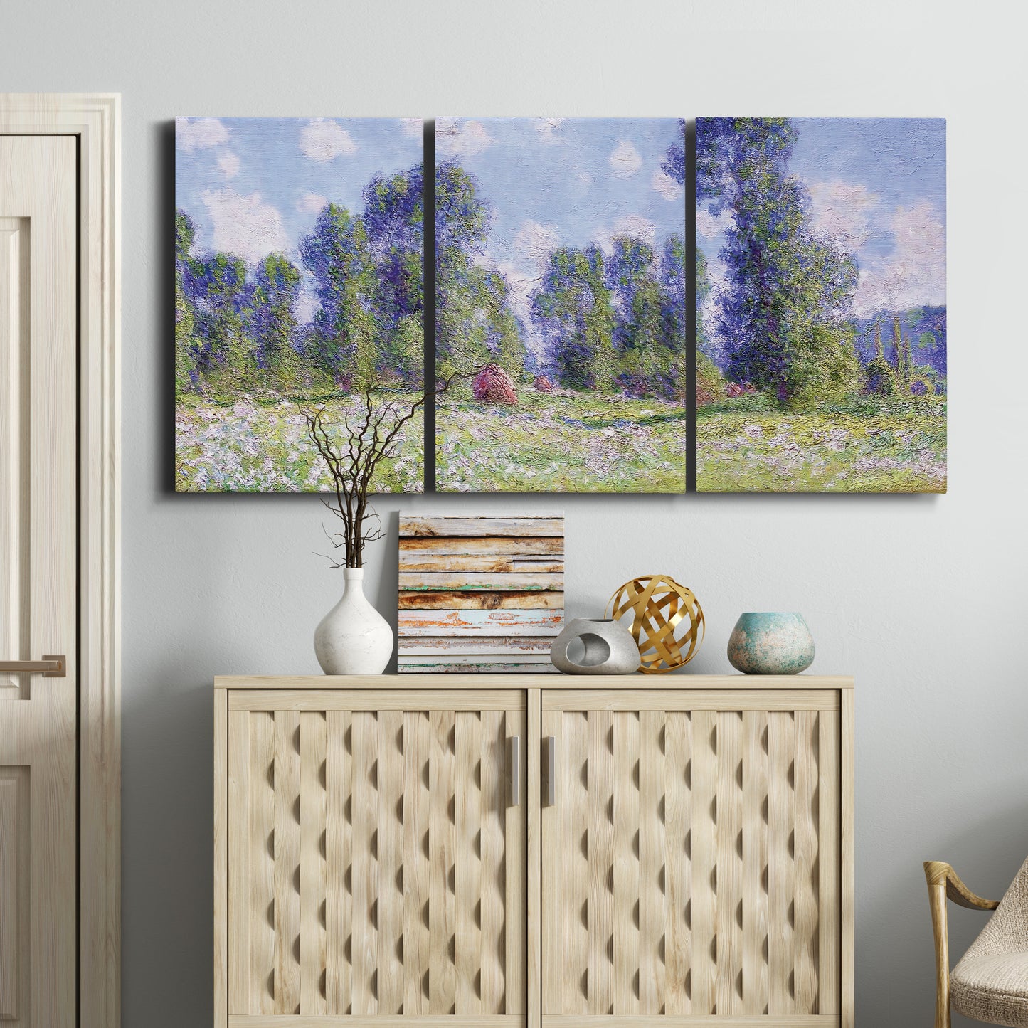 Three-panel canvas wall art featuring poppy field near garden village, displayed above a cabinet in an entryway.