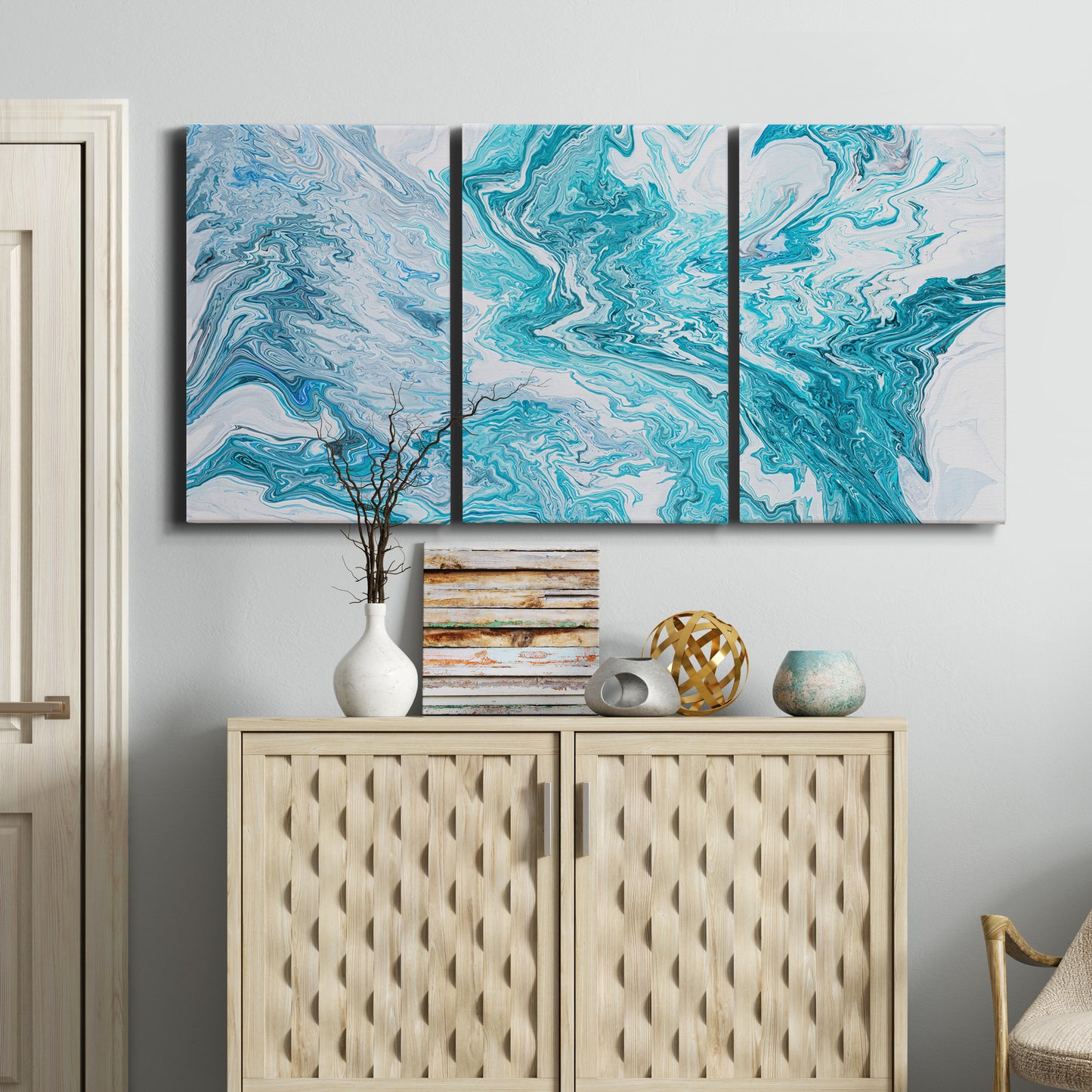 Three-panel canvas wall art featuring rocky coastal tide pool scene, displayed above a cabinet in an entryway.