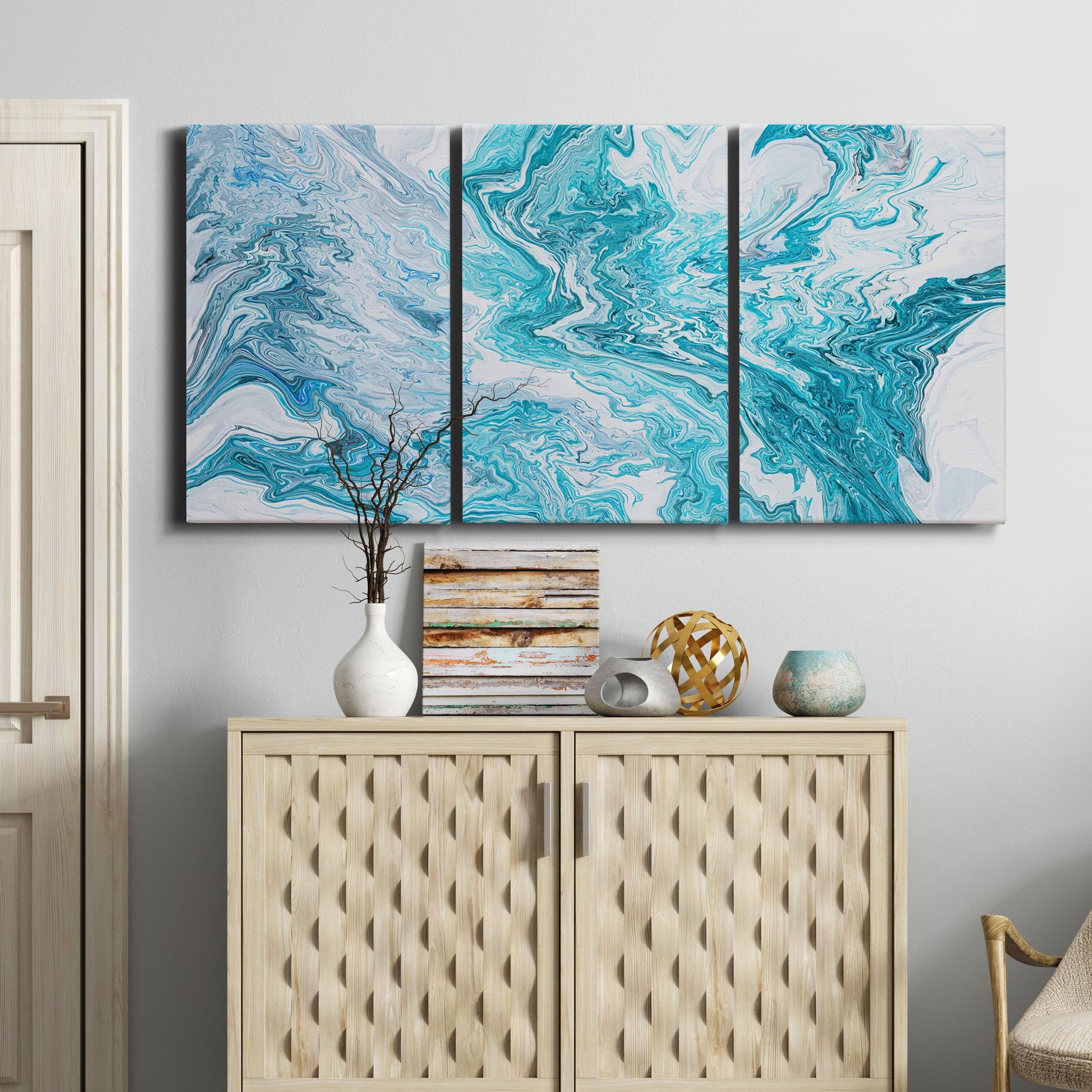 Three-panel canvas wall art featuring rocky coastal tide pool scene, displayed above a cabinet in an entryway.