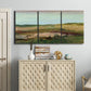 Three-panel canvas wall art featuring pastoral landscape with winding road, displayed above a cabinet in an entryway.