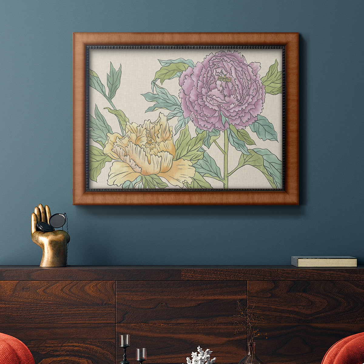 Contemporary peony flower illustration in an ornate vintage burl wood frame displayed in a dark-toned interior setting.