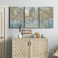 Three-panel canvas wall art featuring abstract river reflections, displayed above a cabinet in an entryway.