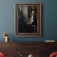 Quiet interior genre scene of a woman with scales by Johannes Vermeer in an ornate bronzed mahogany wood frame displayed in a dark-toned interior setting.