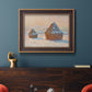 Impressionist winter haystack scene by Claude Monet in an ornate bronzed mahogany wood frame displayed in a dark-toned interior setting.