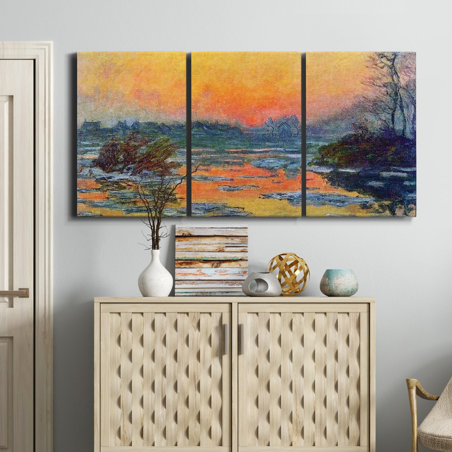Three-panel canvas wall art featuring winter sunset over river, displayed above a cabinet in an entryway.