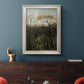 Dreamlike forest landscape scene by Henri Rousseau in an ornate champagne frame displayed in a dark-toned interior setting.