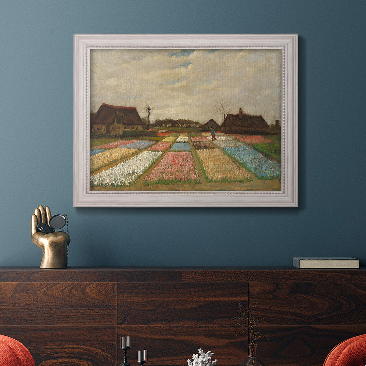 Impressionist Dutch bulb field landscape by Vincent van Gogh in an ornate weathered white frame displayed in a dark-toned interior setting.