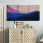 Three-panel canvas wall art featuring smooth abstract sunset color gradient, displayed above a cabinet in an entryway.