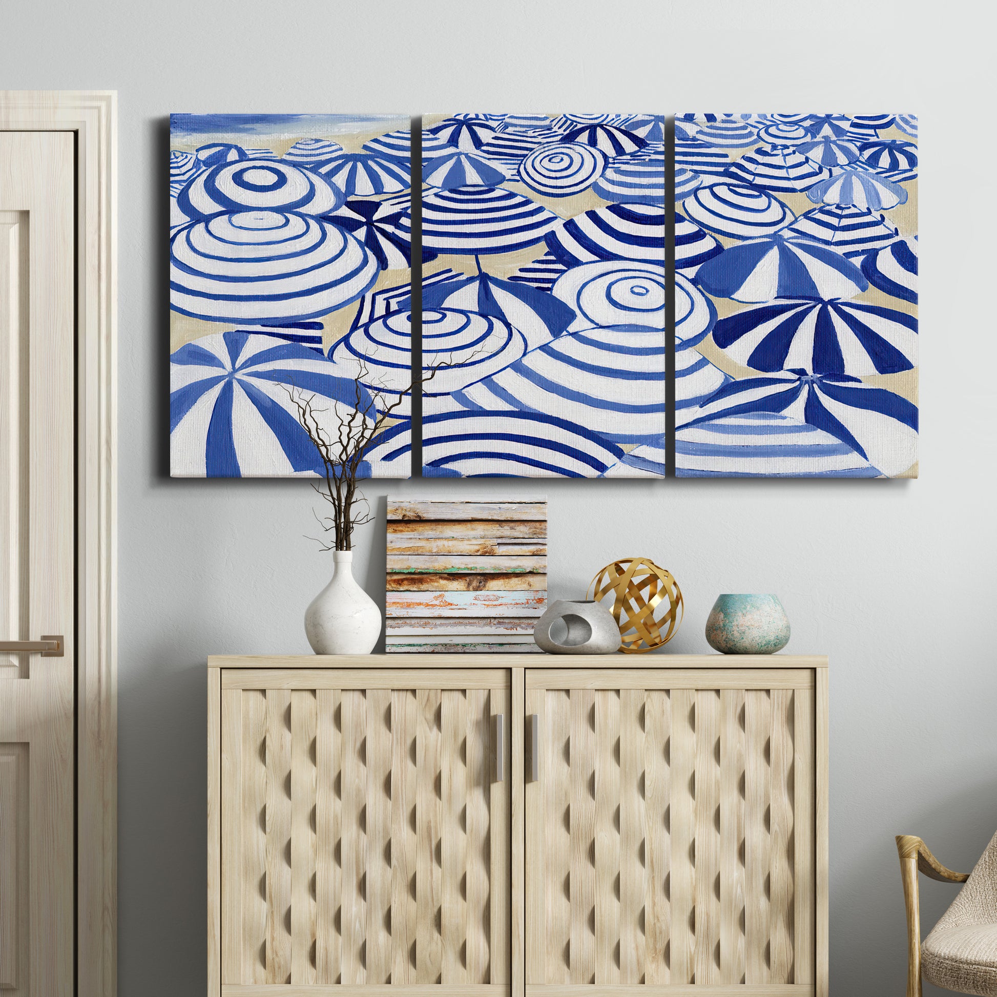 Three-panel canvas wall art featuring geometric abstract bowl forms, displayed above a cabinet in an entryway.