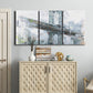 Three-panel canvas wall art featuring urban cityscape with architectural forms, displayed above a cabinet in an entryway.