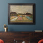 Impressionist Dutch bulb field landscape by Vincent van Gogh in an ornate black frame with gilded inner detail displayed in a dark-toned interior setting.