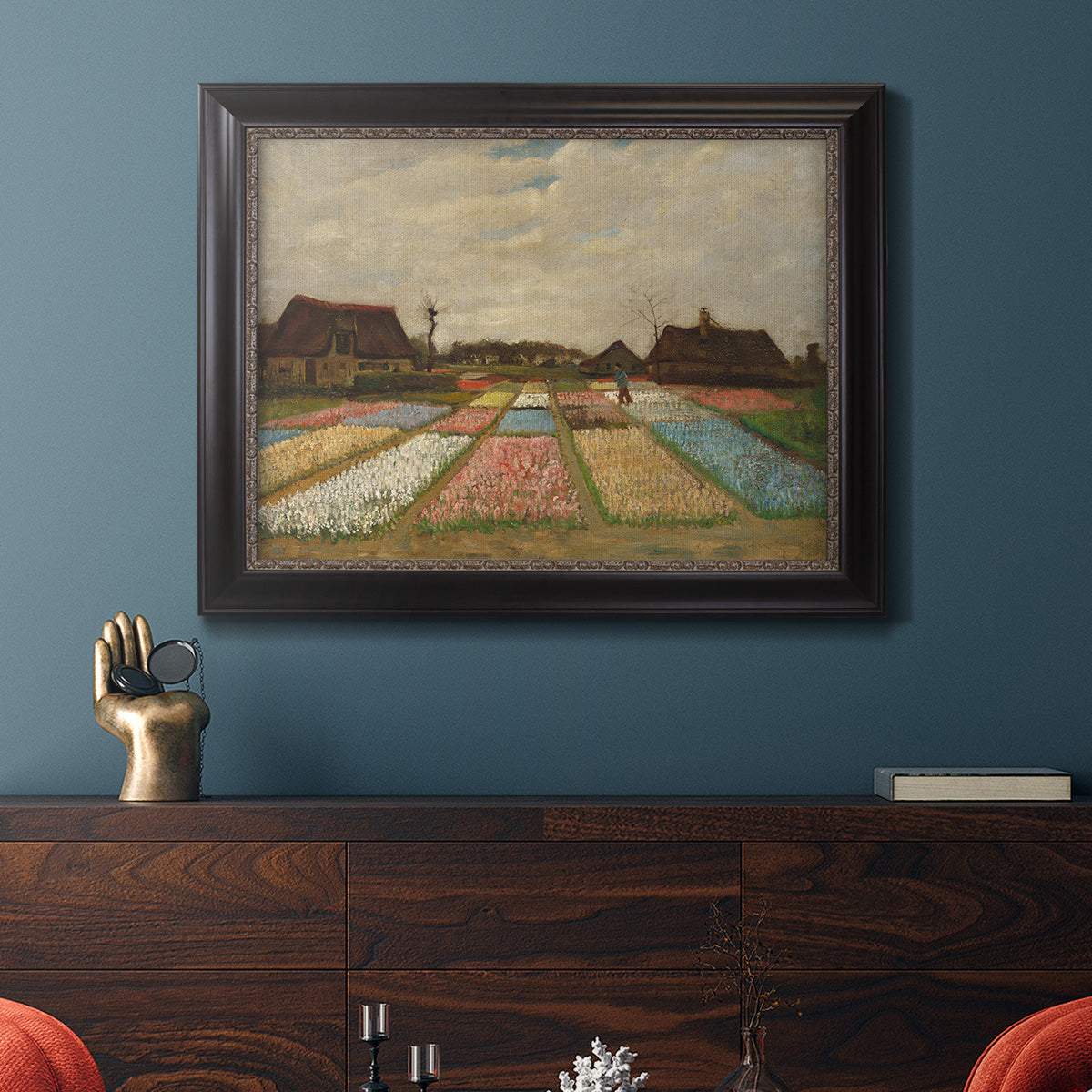 Impressionist Dutch bulb field landscape by Vincent van Gogh in an ornate black frame with gilded inner detail displayed in a dark-toned interior setting.