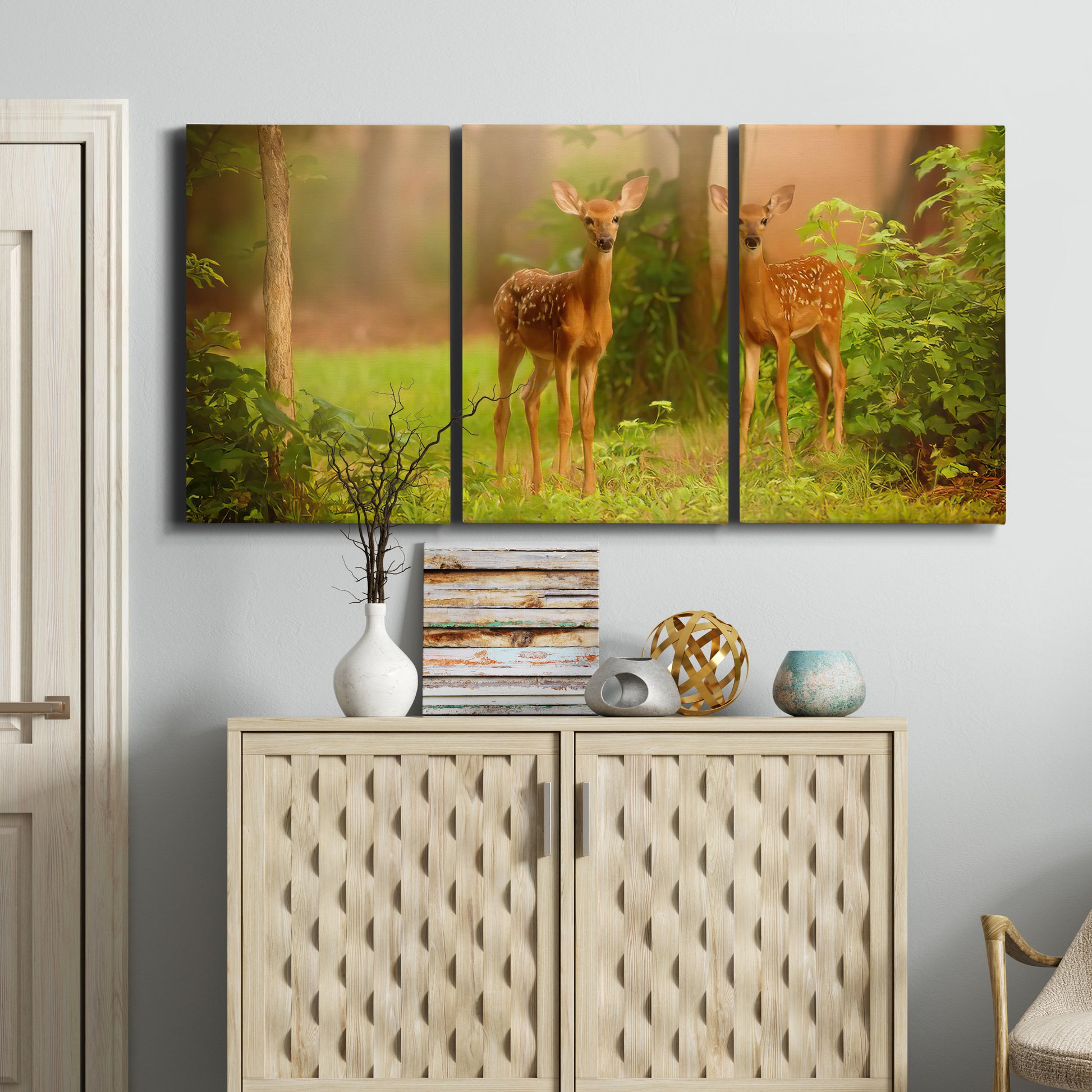 Three-panel canvas wall art featuring resting animals in open field, displayed above a cabinet in an entryway.