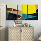 Three-panel canvas wall art featuring geometric mid century abstract blocks, displayed above a cabinet in an entryway.