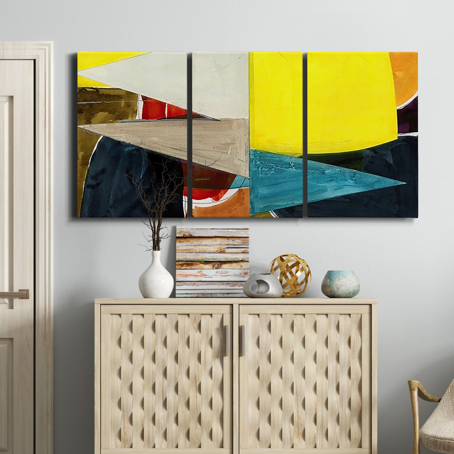 Three-panel canvas wall art featuring geometric mid century abstract blocks, displayed above a cabinet in an entryway.