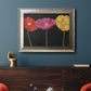 Contemporary poppy flower artwork in an ornate mottled silver frame displayed in a dark-toned interior setting.