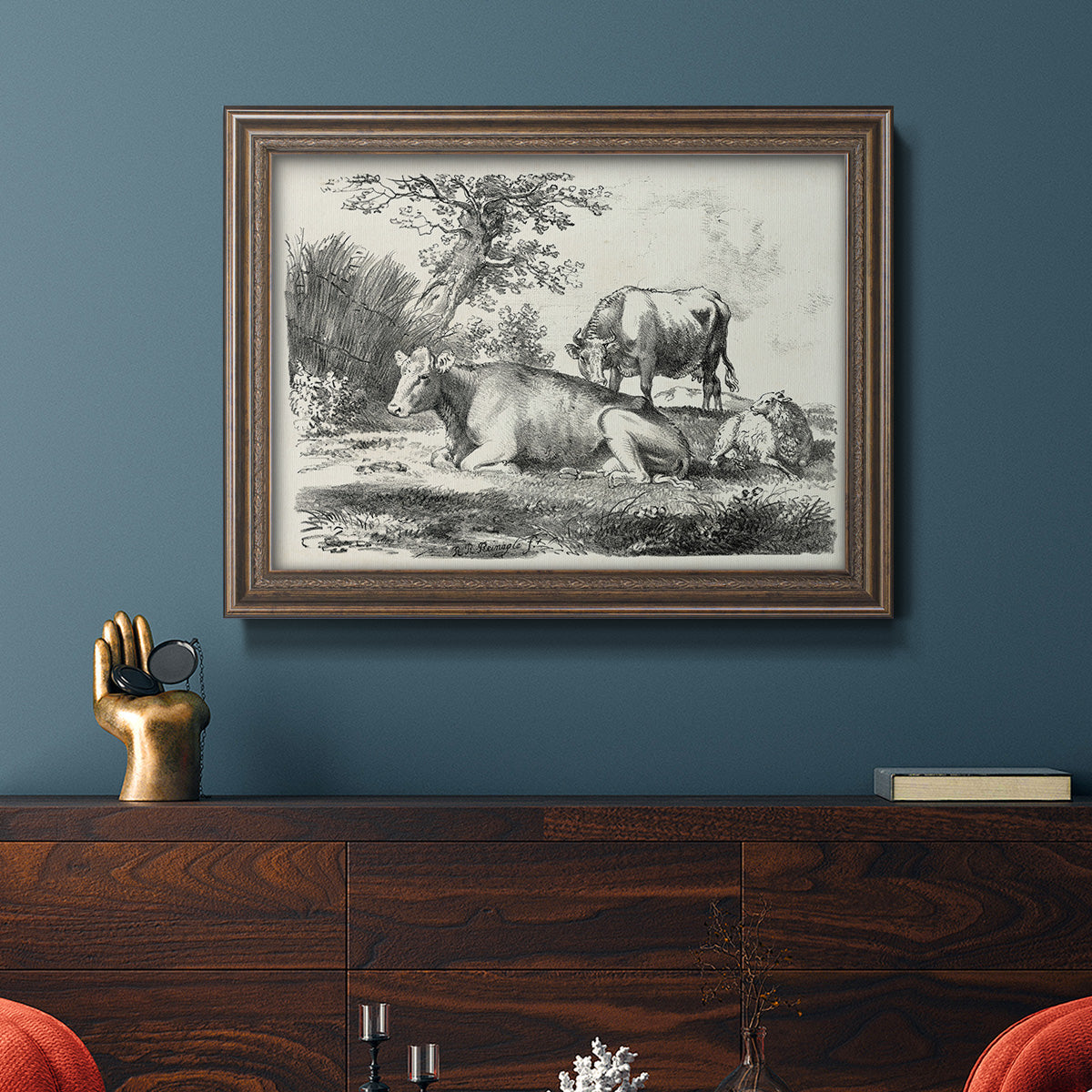 Classical pastoral landscape artwork by Nicolas Berchem in an ornate traditional bronze frame displayed in a dark-toned interior setting.
