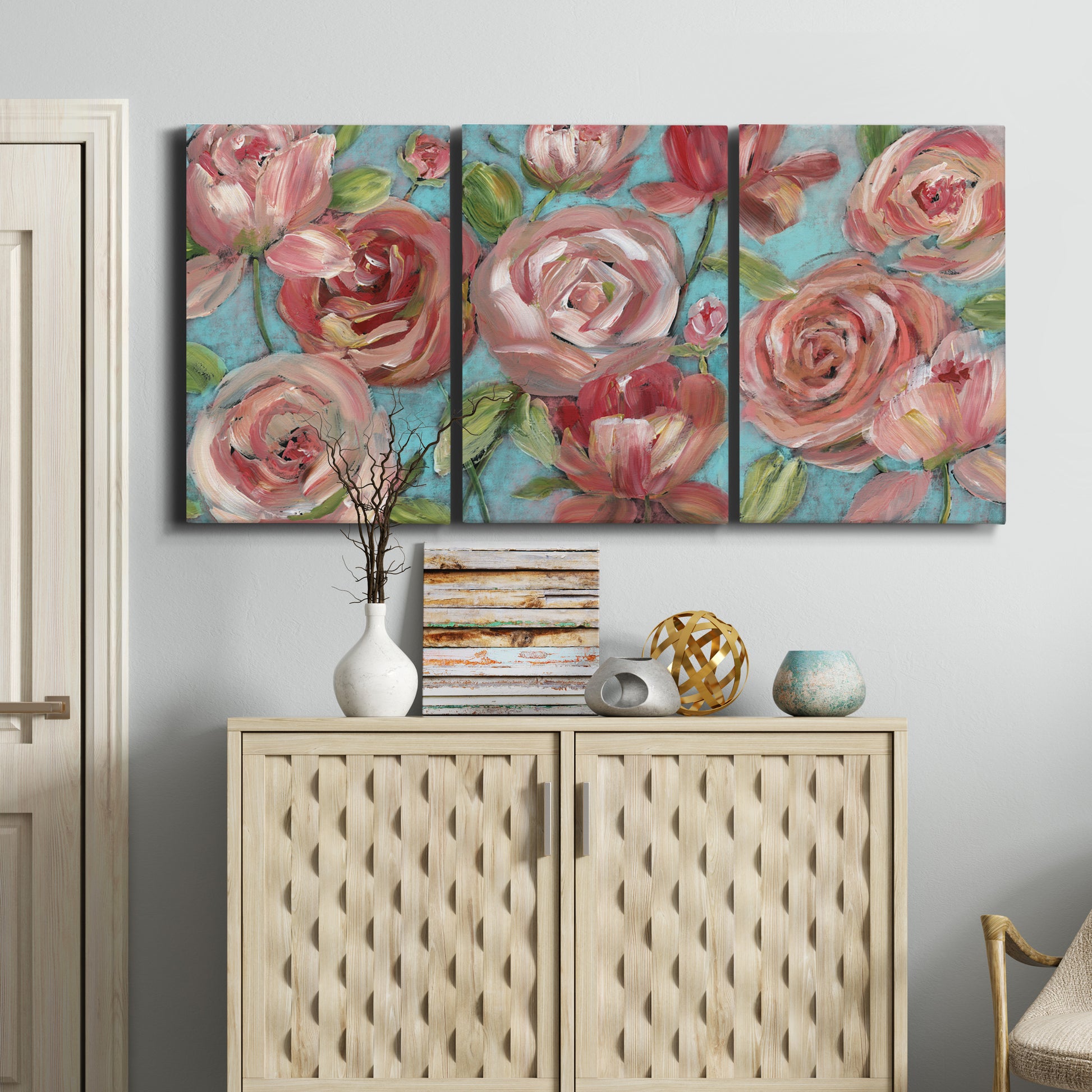 Three-panel canvas wall art featuring playful peach toned floral composition, displayed above a cabinet in an entryway.