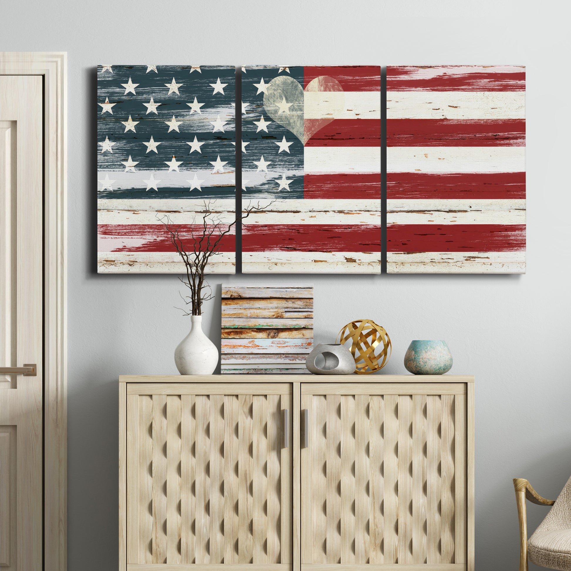Three-panel canvas wall art featuring rustic american flag country style, displayed above a cabinet in an entryway.