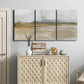 Three-panel canvas wall art featuring golden hour light over landscape, displayed above a cabinet in an entryway.