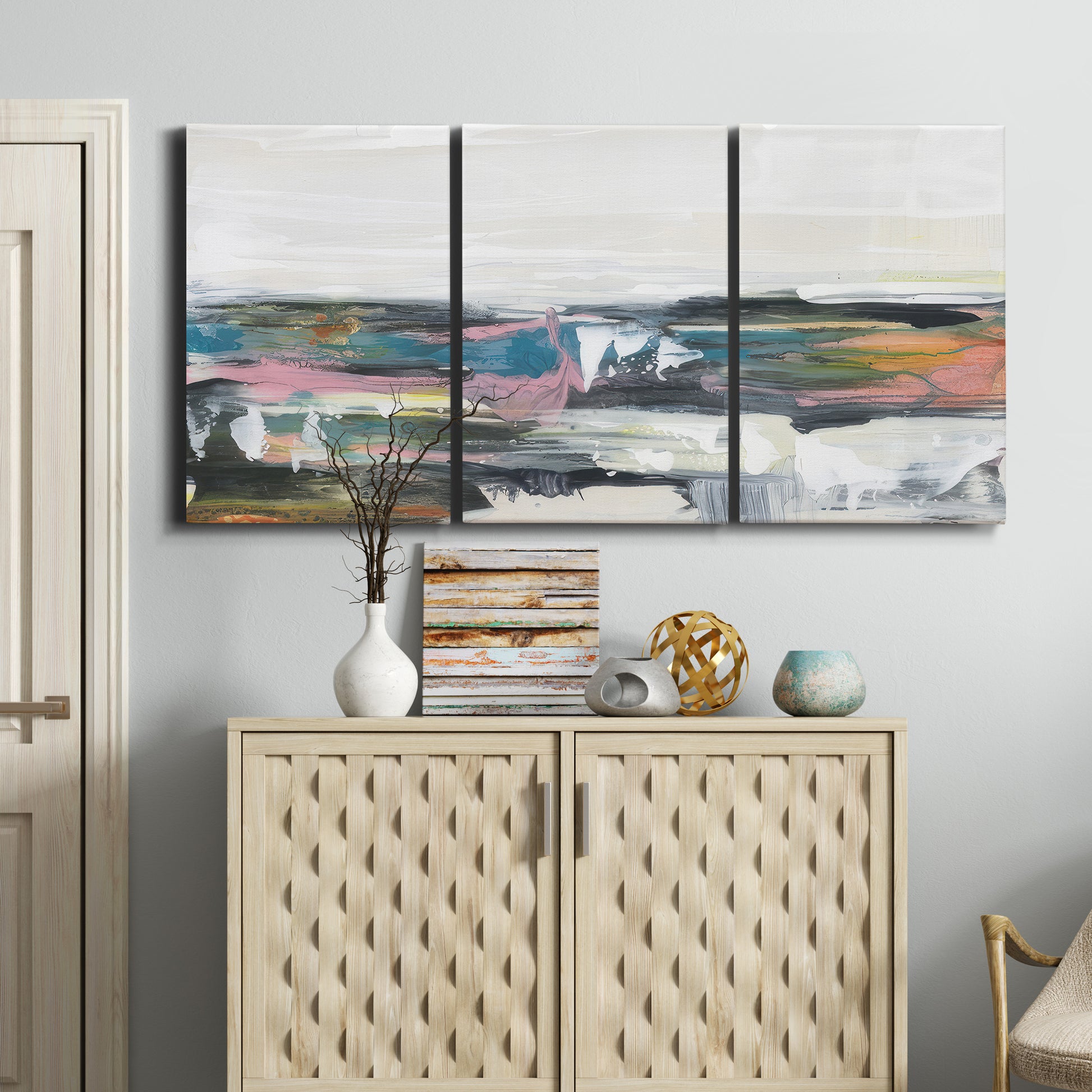 Three-panel canvas wall art featuring cheerful abstract coastal seascape, displayed above a cabinet in an entryway.