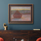 Impressionist haystack sunset scene in winter by Claude Monet in an ornate bronzed mahogany wood frame displayed in a dark-toned interior setting.