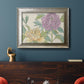 Contemporary peony flower illustration in an ornate mottled silver frame displayed in a dark-toned interior setting.