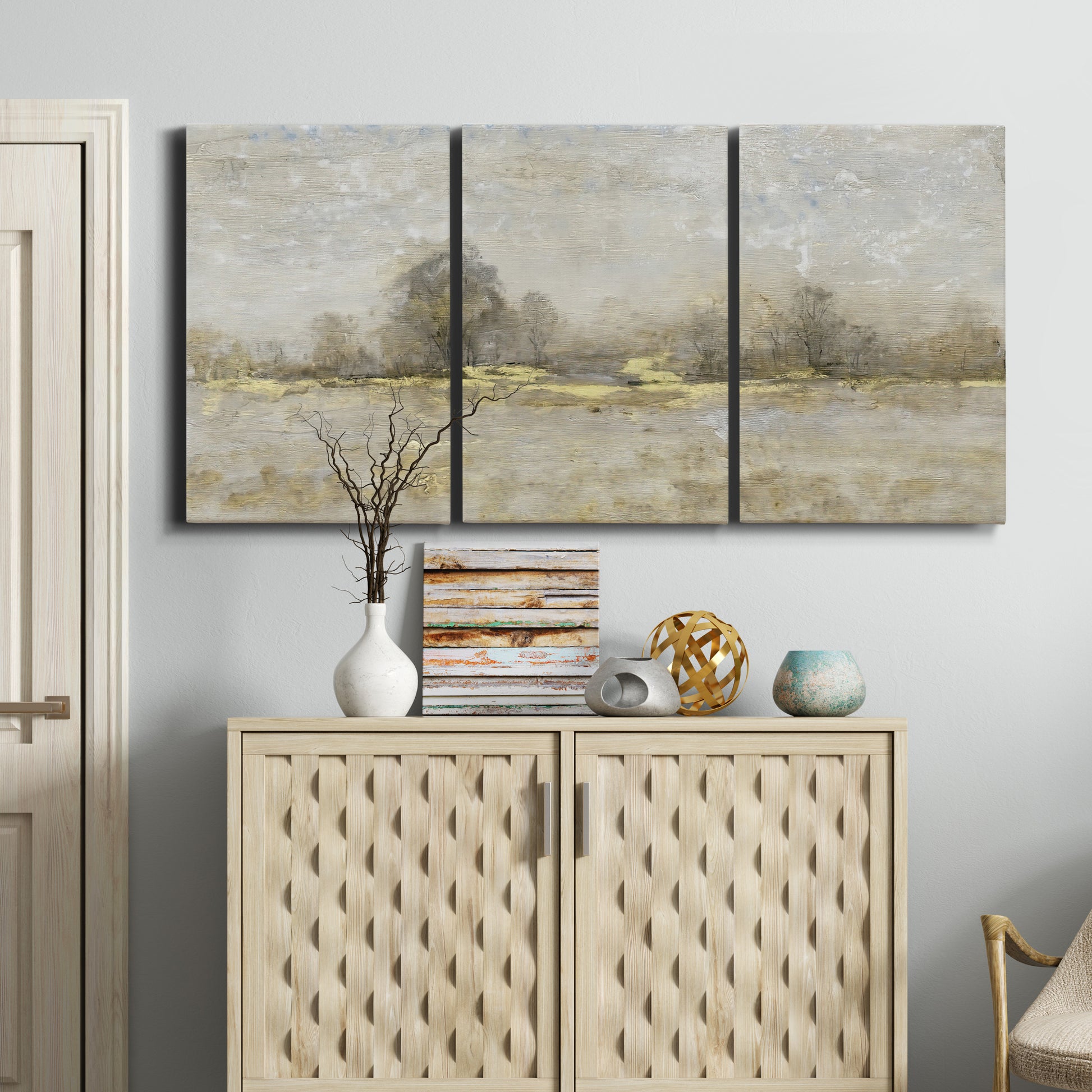 Three-panel canvas wall art featuring late season rural harvest fields, displayed above a cabinet in an entryway.